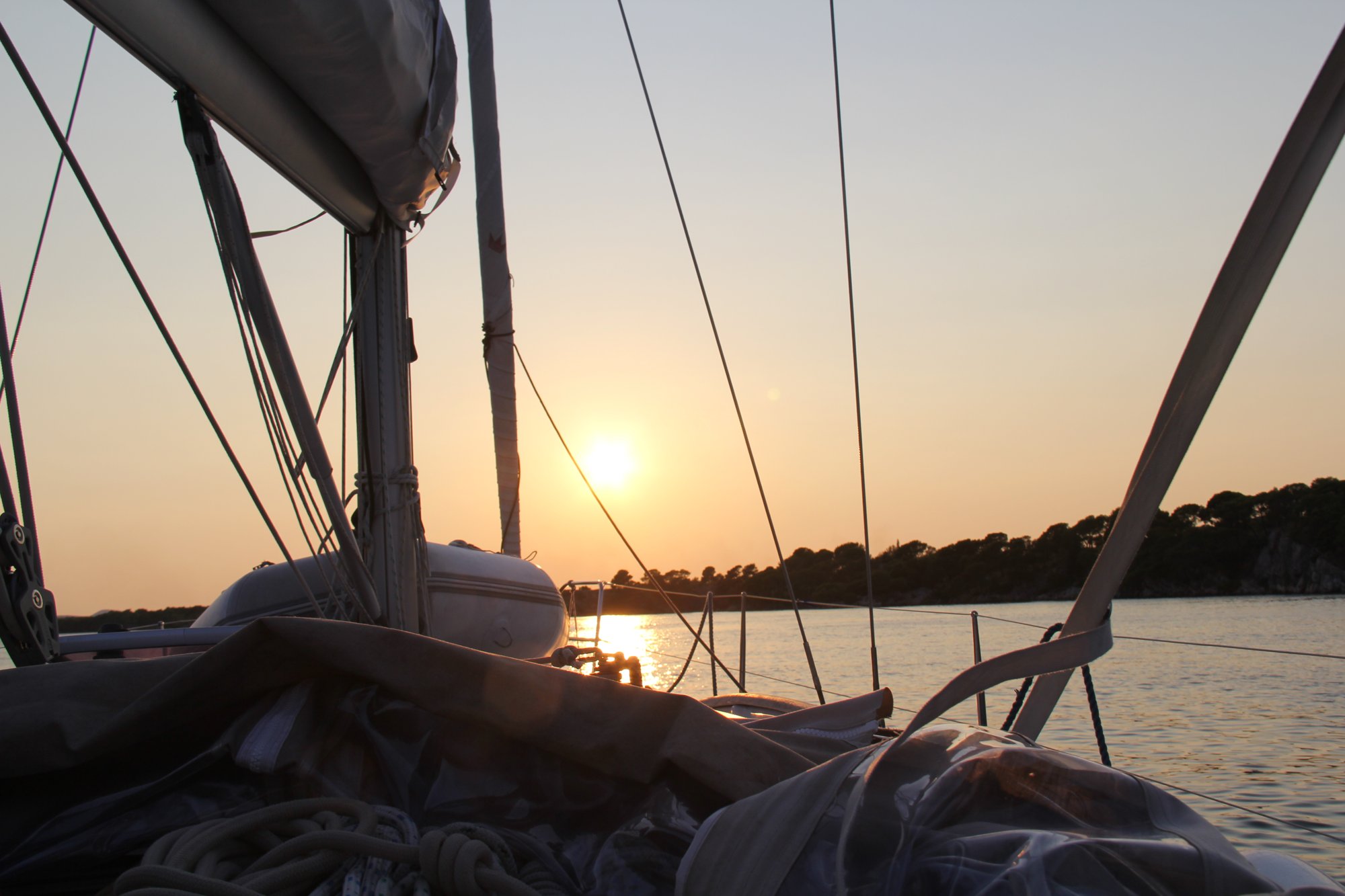 Sunset through the rigging of a sailboat