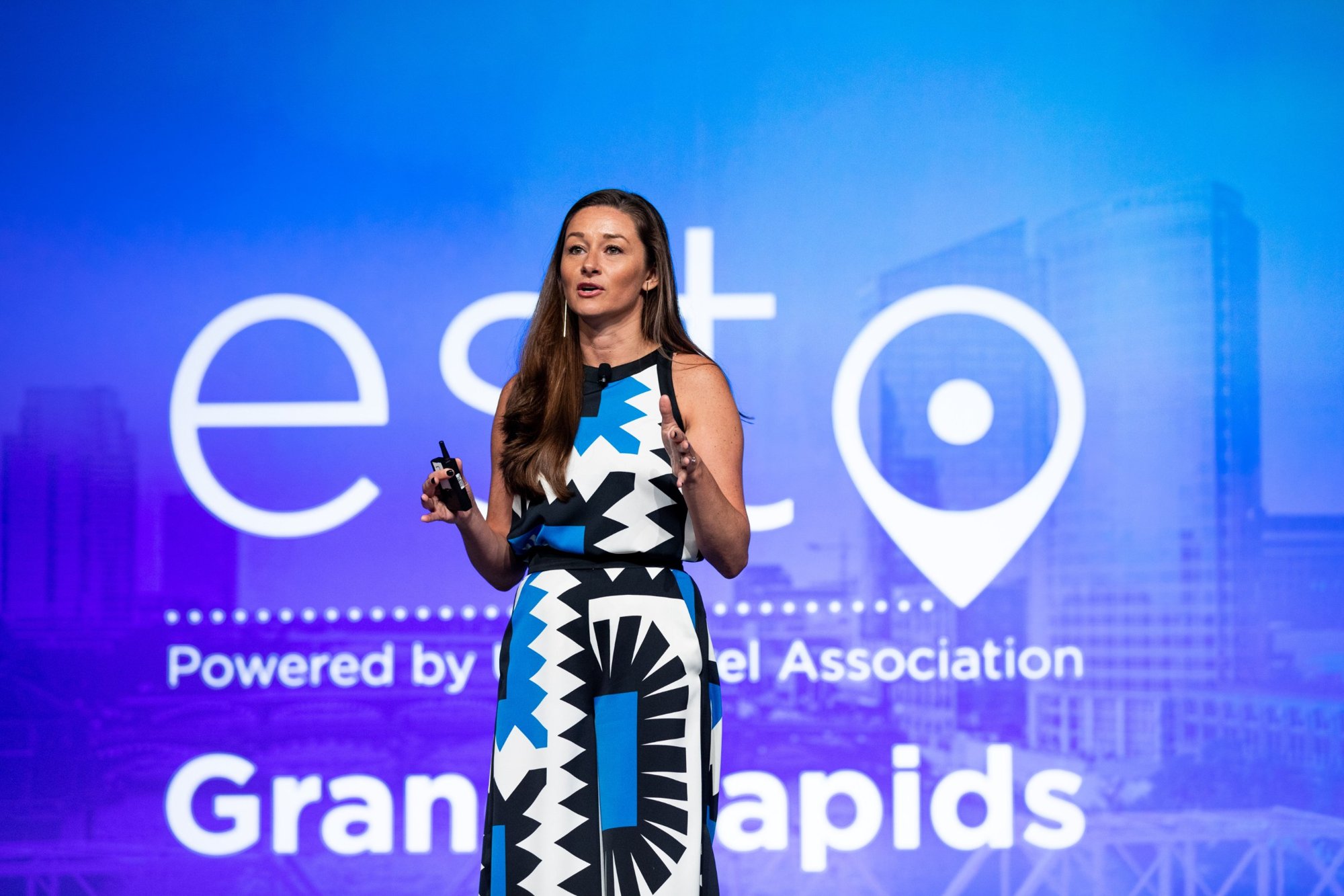 Danielle Posa speaking on stage at ESTO, the U.S. Travel Association conference, in Grand Rapids